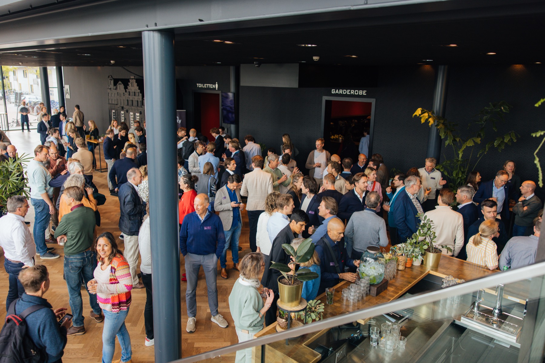 Crowded venue foyer during a reception